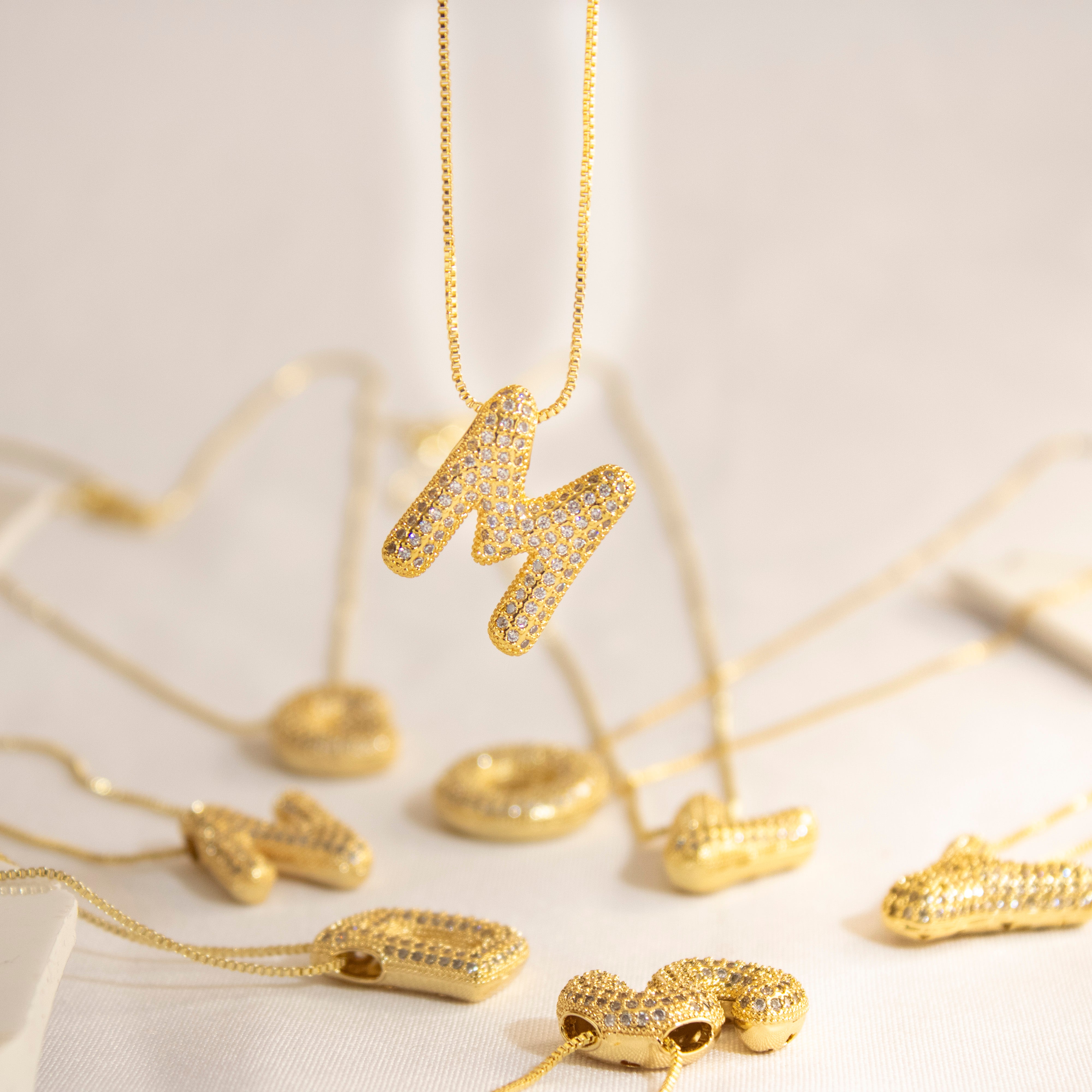 Collection of Inicial con Zirconia tipo globo y cadena con chapa de oro in a gallery layout